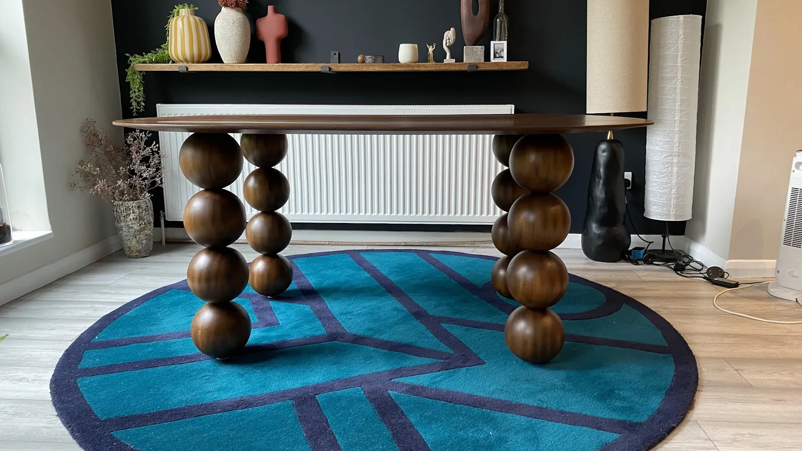 The Orbital dinette table against a dark wall